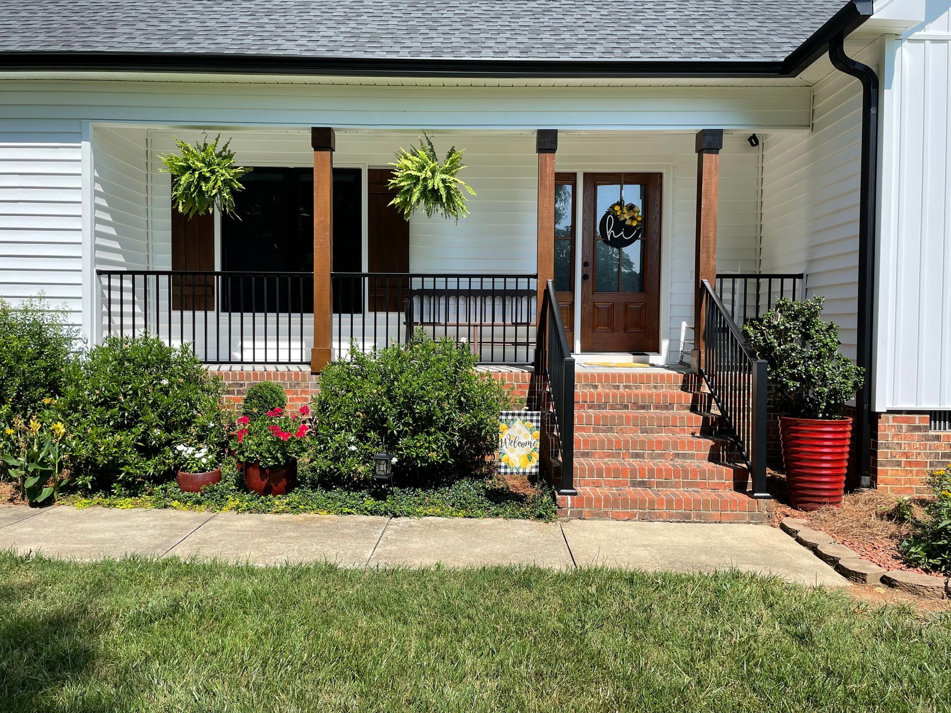 A white house with a porch and stairs
