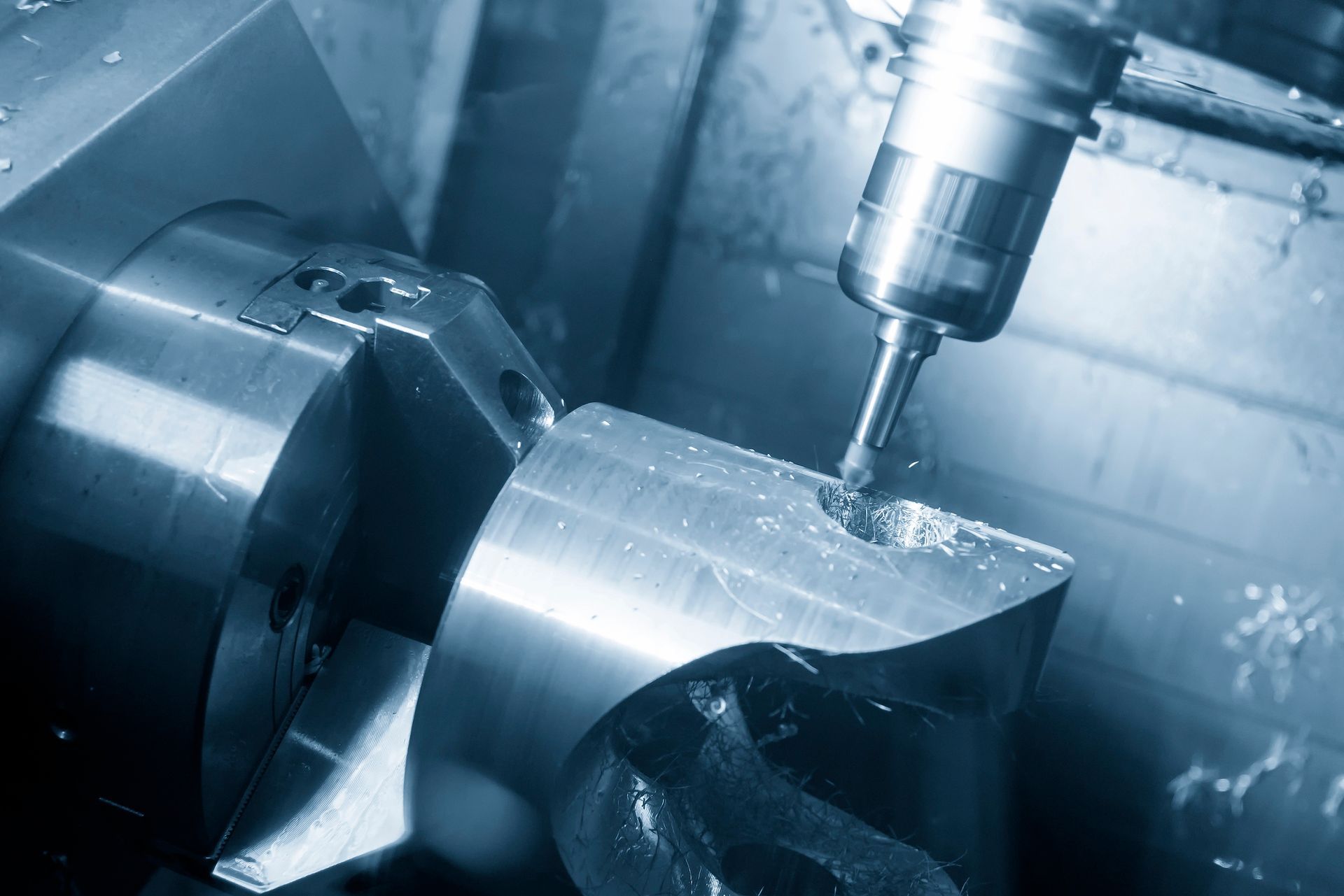 A cnc machine is cutting a piece of metal in a factory.
