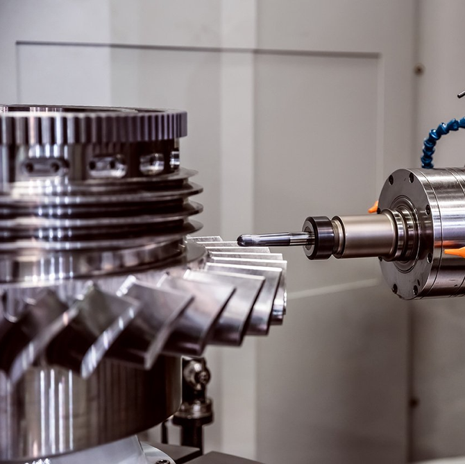 A machine is cutting a metal gear in a factory.