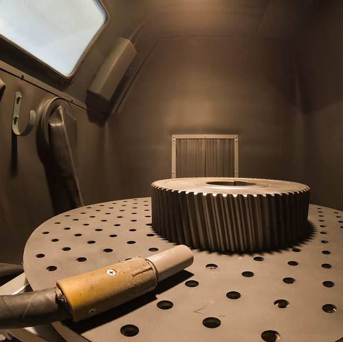 A large gear sits on a table in a room