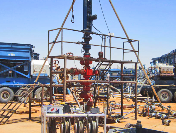 A large metal object is being turned on a machine.