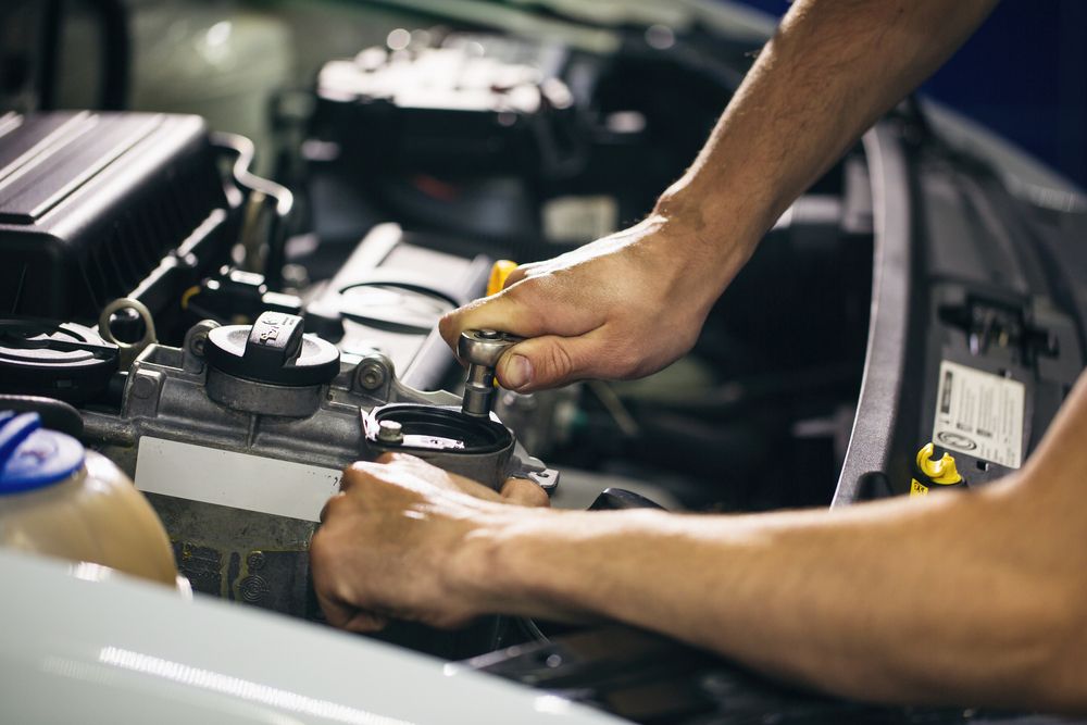 Person Working on a Car Engine — Secure Diesel & Automotive in Ryan, QLD