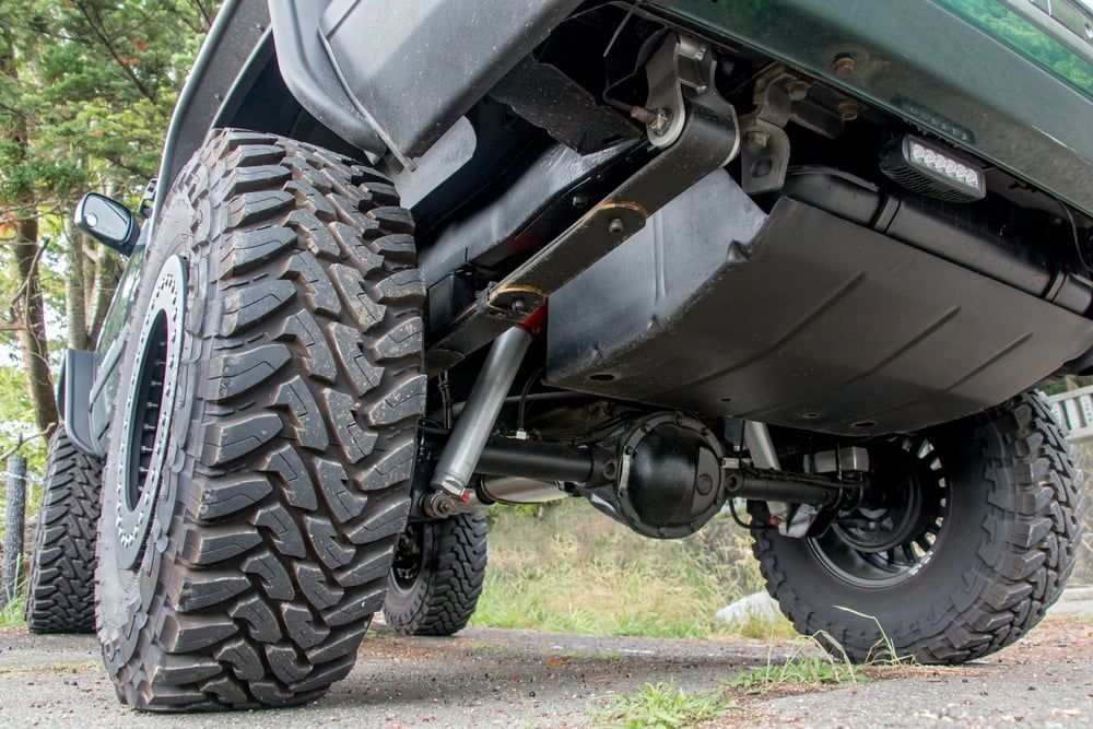 A Close Up of the Underside of a Truck With a Large Tire — Secure Diesel & Automotive in Boulia, QLD