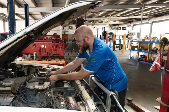 A Man is Working on the Engine of a Car in a Garage — Bob Parkes Automotive in Hyde Park, QLD
