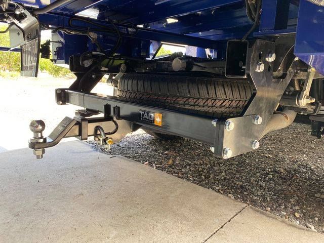 A Blue Truck With a Trailer Attached to It is Parked on the Side of the Road — Bob Parkes Automotive in Hyde Park, QLD