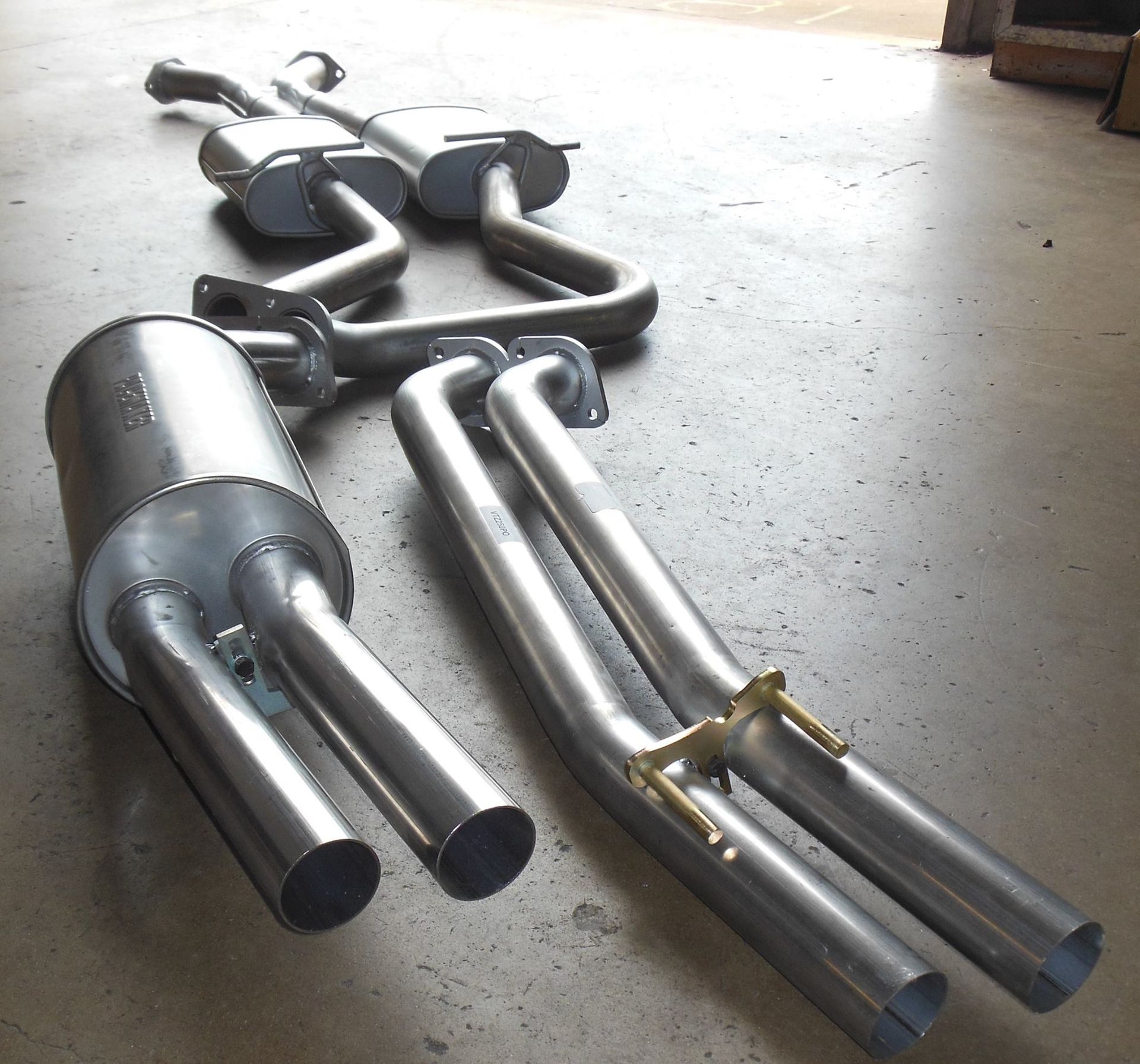 A Bunch of Exhaust Pipes Are Laying on the Ground — Bob Parkes Automotive in Hyde Park, QLD