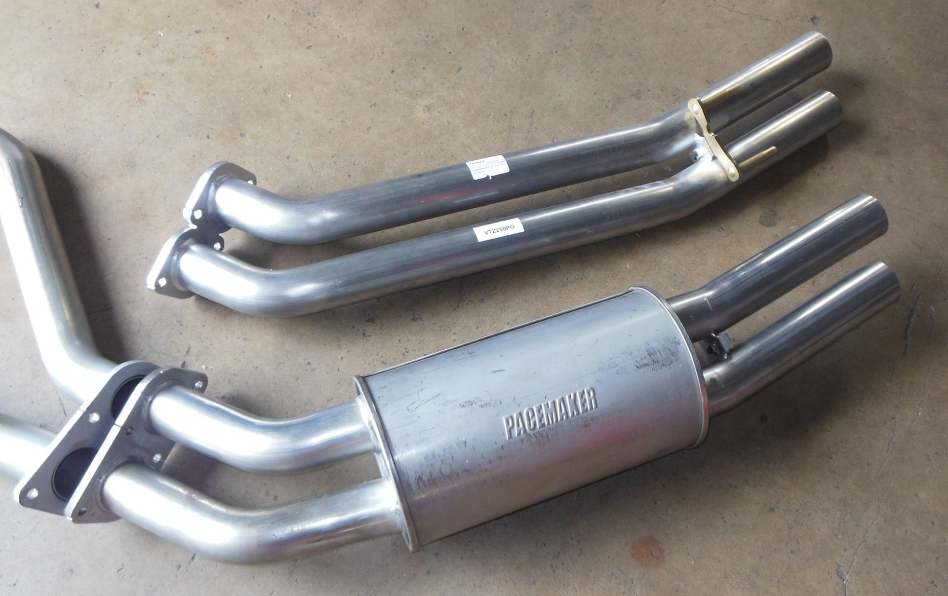 A Couple of Exhaust Pipes With One That Says ' Racing ' on It — Bob Parkes Automotive in Hyde Park, QLD