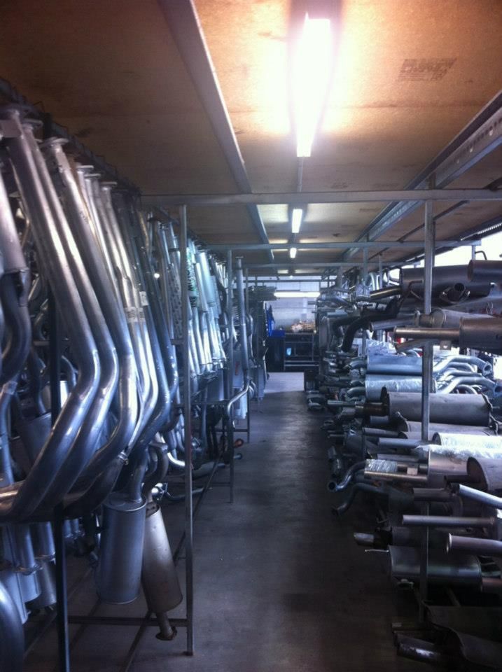 A Warehouse Filled With Lots of Exhaust Pipes — Bob Parkes Automotive in Hyde Park, QLD