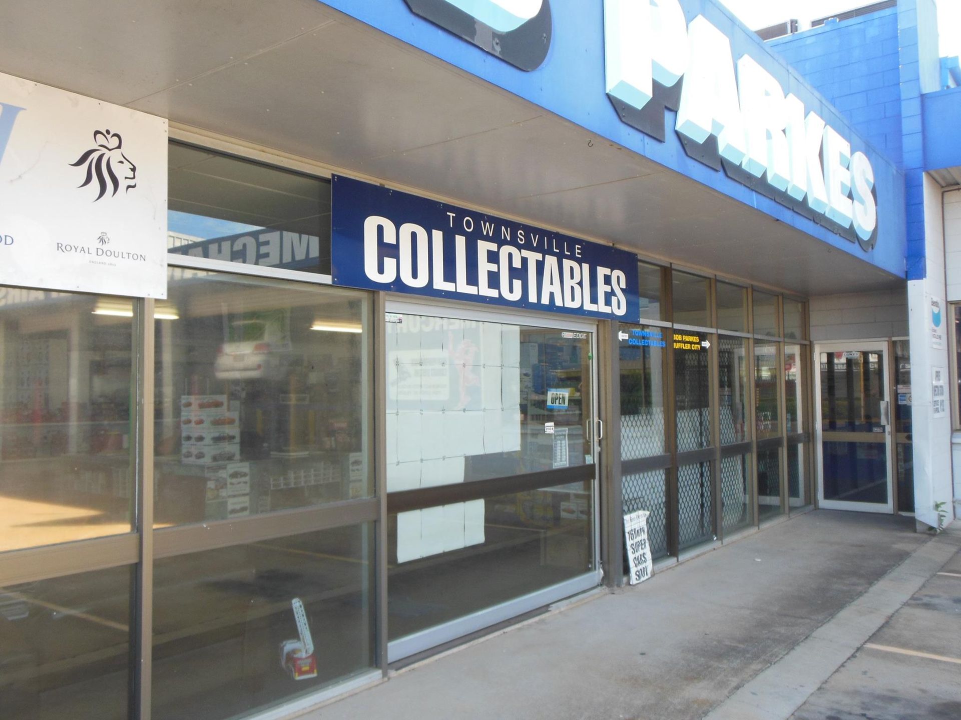 The Outside of a Collectables Store With a Blue Sign — Bob Parkes Automotive in Hyde Park, QLD