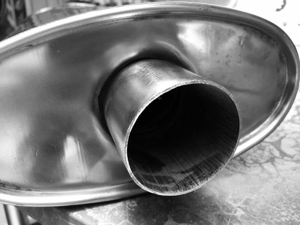 A Close Up of a Stainless Steel Exhaust Pipe on a Table — Bob Parkes Automotive in Hyde Park, QLD