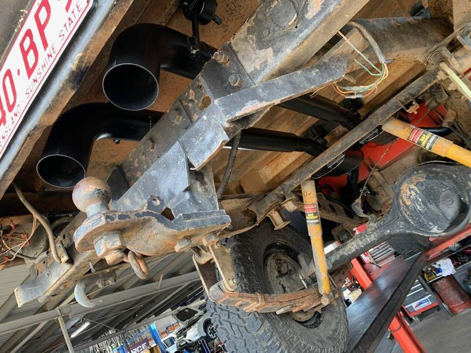 A Truck is Sitting on a Lift in a Garage — Bob Parkes Automotive in Hyde Park, QLD