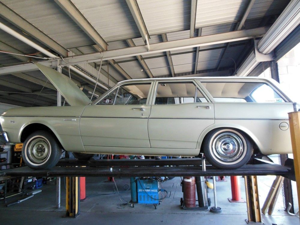 A Station Wagon is Sitting on a Lift in a Garage — Bob Parkes Automotive in Hyde Park, QLD