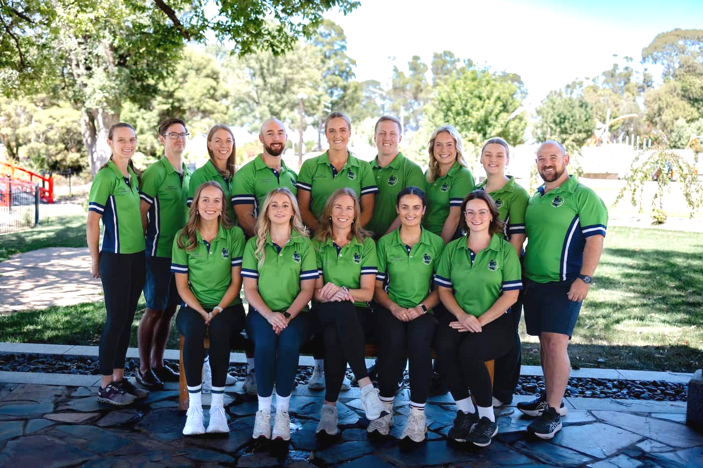 Group of People in Green Shirts, Posing Outdoors — Goulburn Physiotherapy Centre in Goulburn, NSW