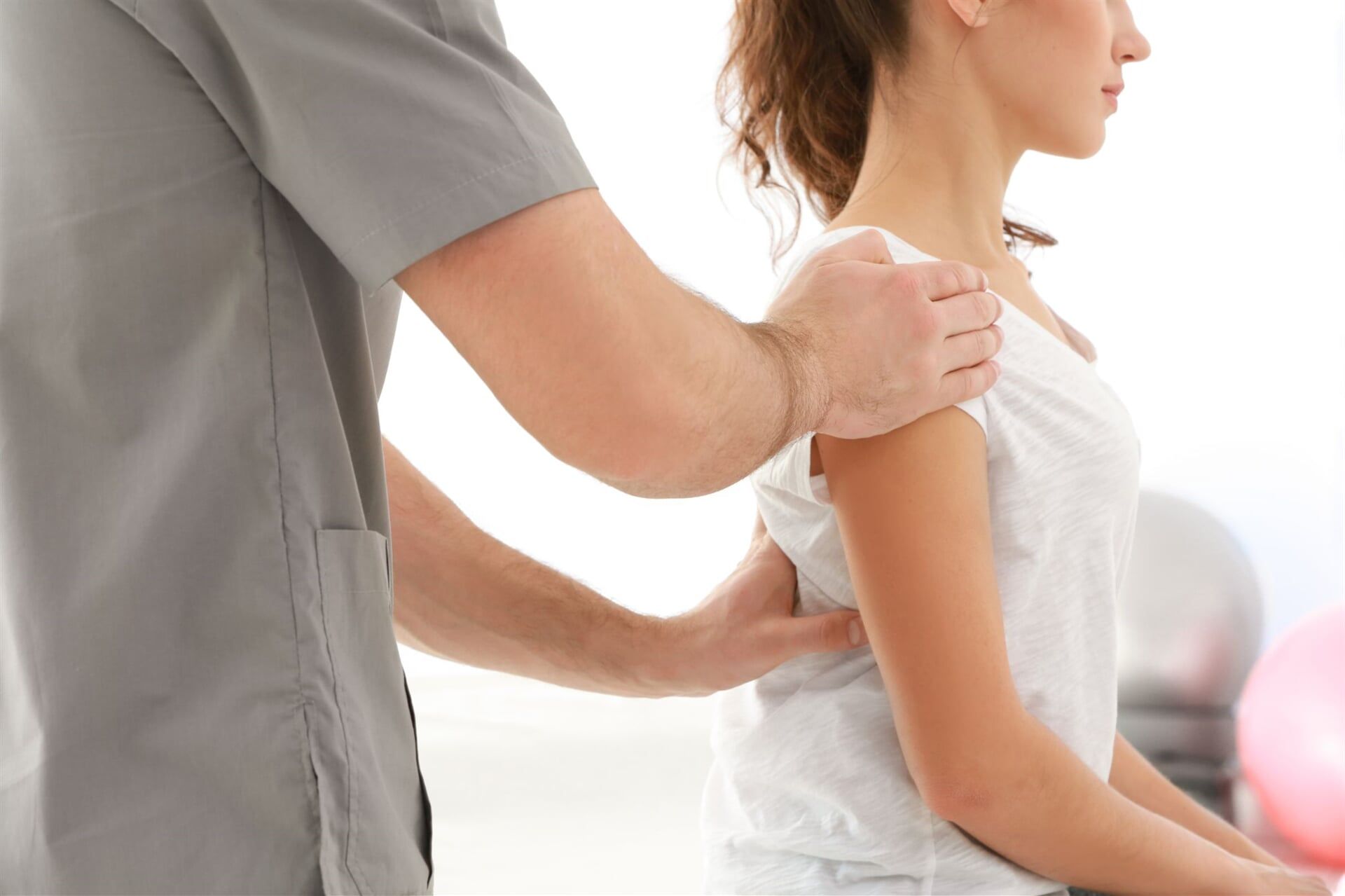 Physical Therapist Fixing Woman's Spine Deformation — Physiotherapists in Goulburn, NSW