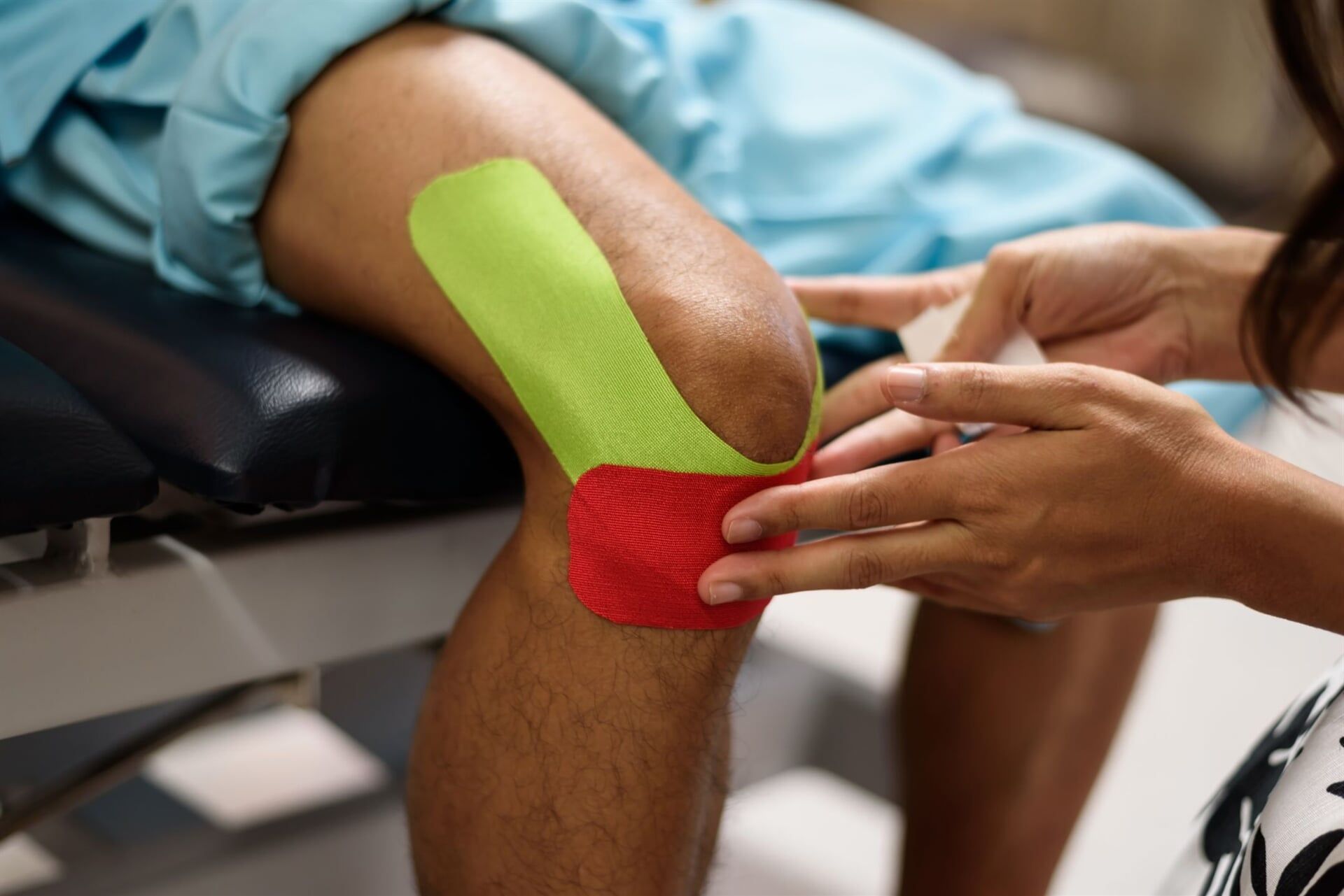 Physical therapist applying kinesio tape — Physiotherapists in Goulburn,, NSW