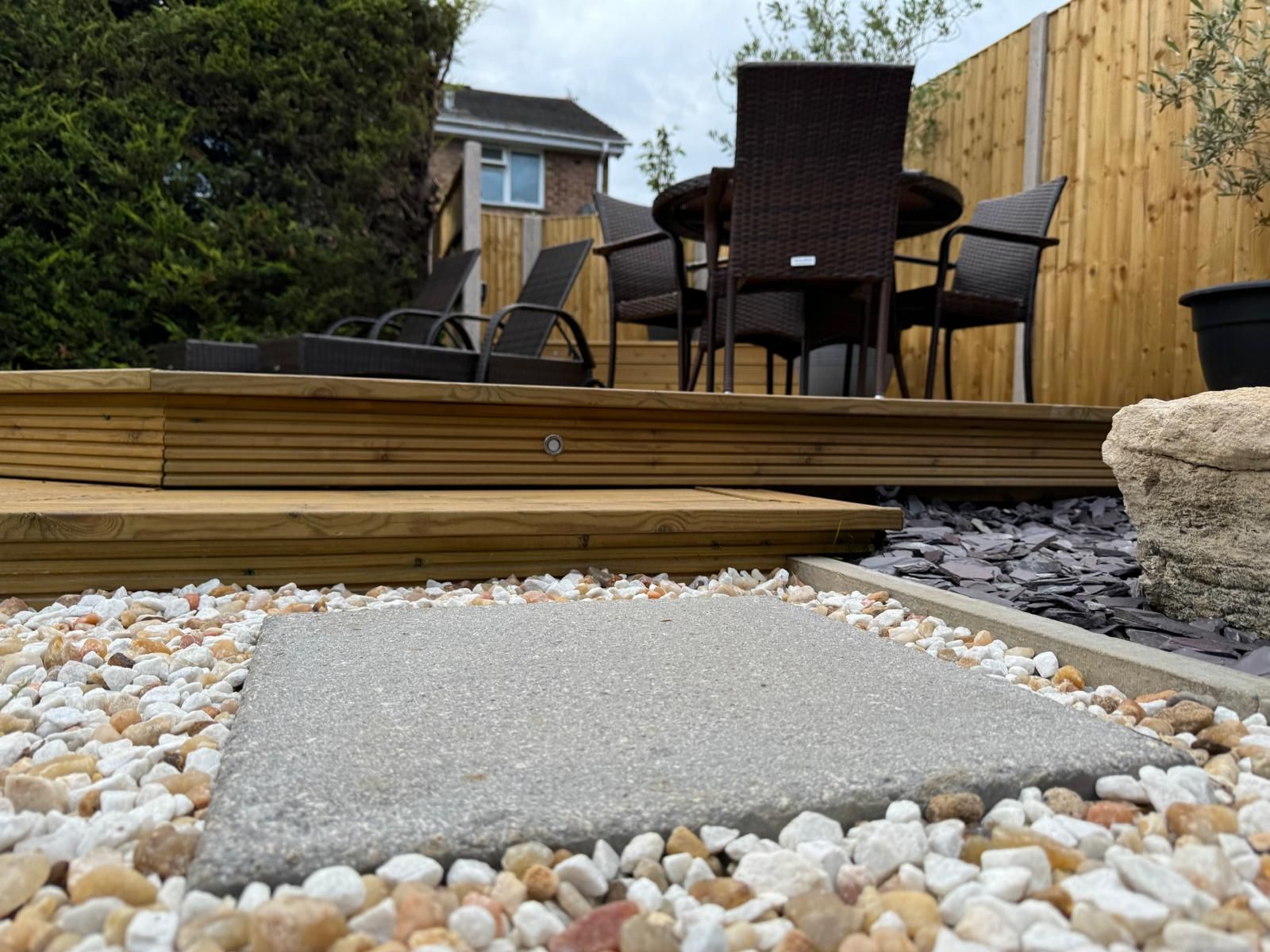 A wooden deck with a table and chairs on it