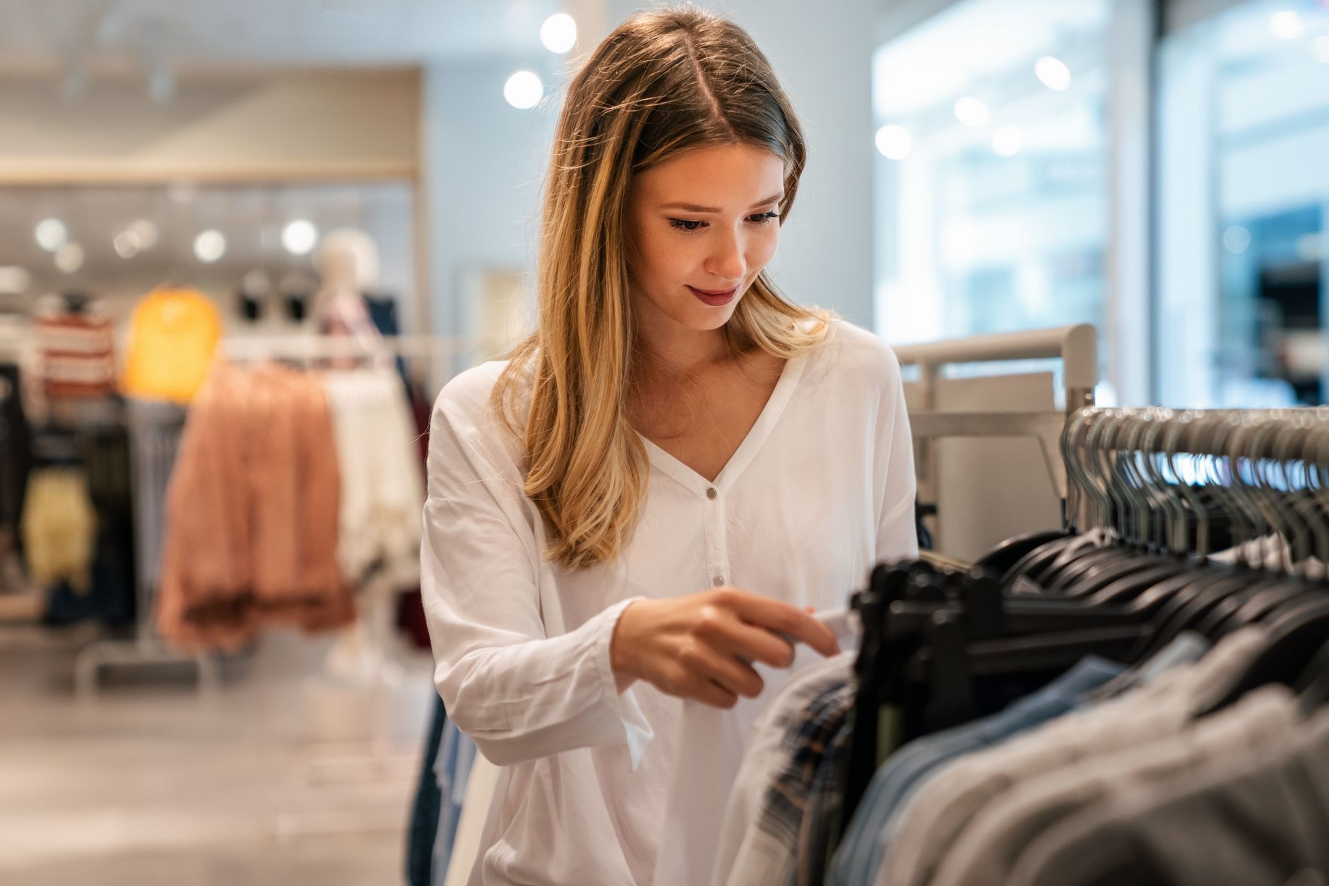 A man and a woman are walking through a store holding bags that say union fashion.