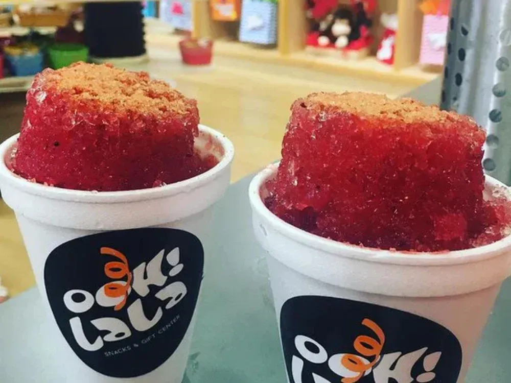 Two cups of ice cream are sitting on a table