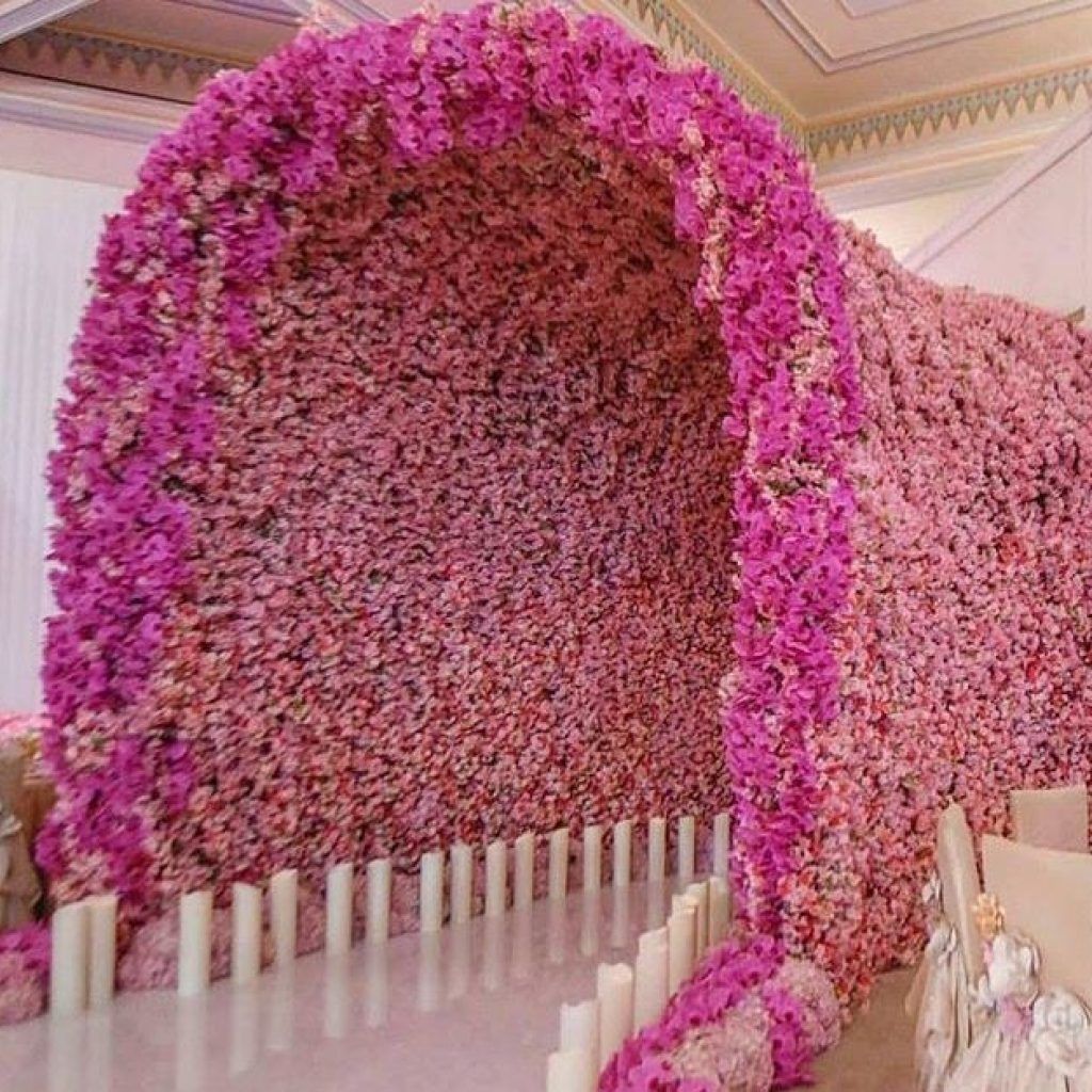 Pink floral tunnel entrance at an elegant indoor event venue