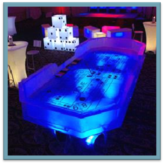Glowing blue tabletop game setup in a dim lounge, with illuminated dice and seating nearby