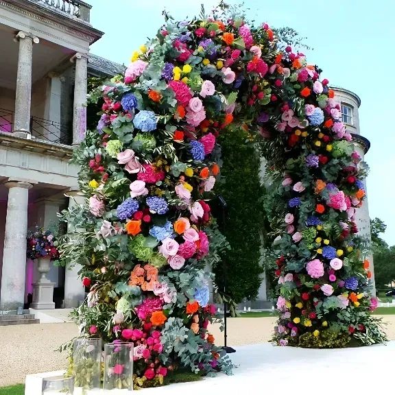 Flower-covered archway outdoors beside a neoclassical building