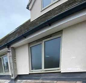 a black UPVC gutter on a house