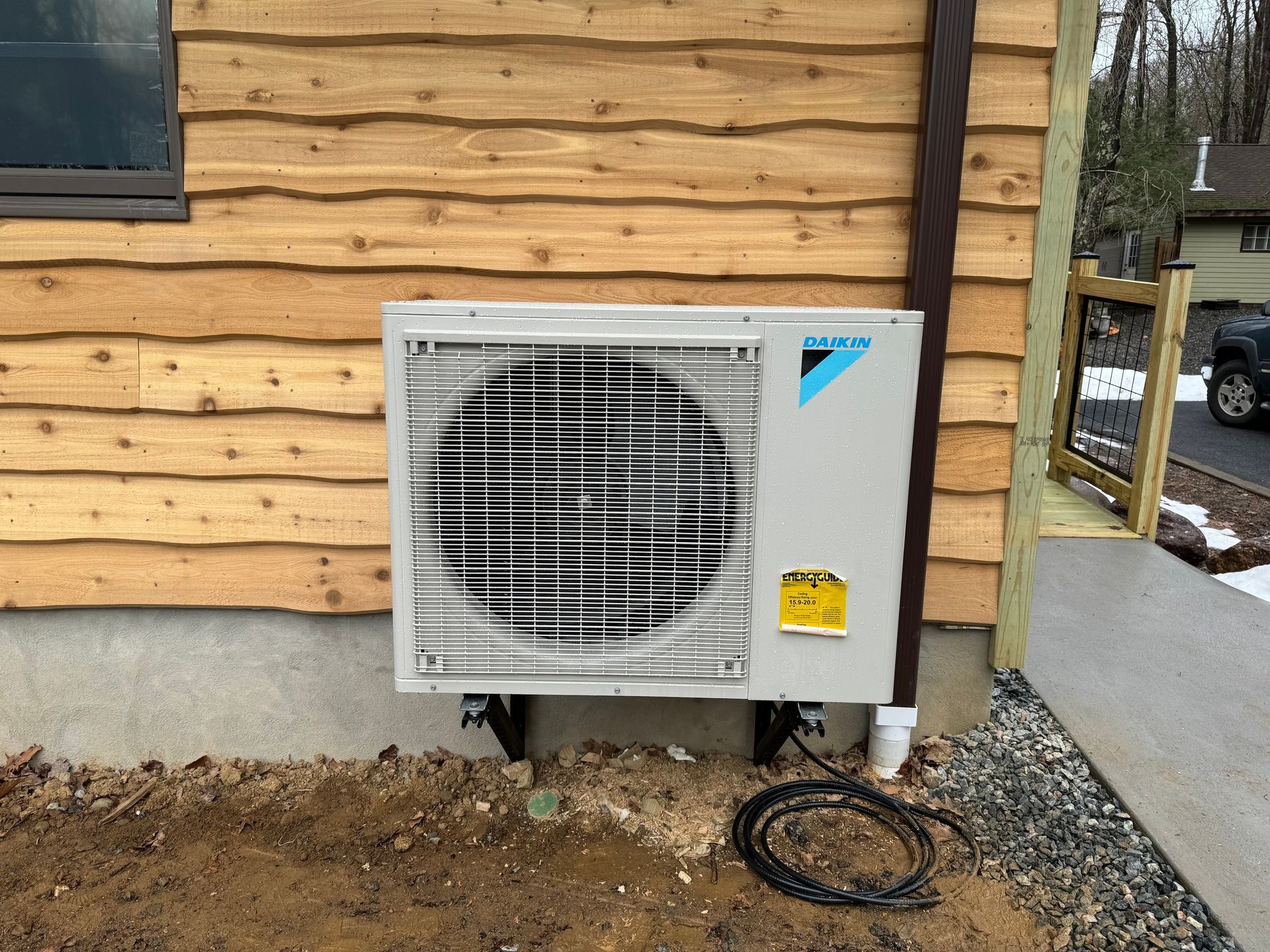 A wooden fence is sitting on top of a lush green field.