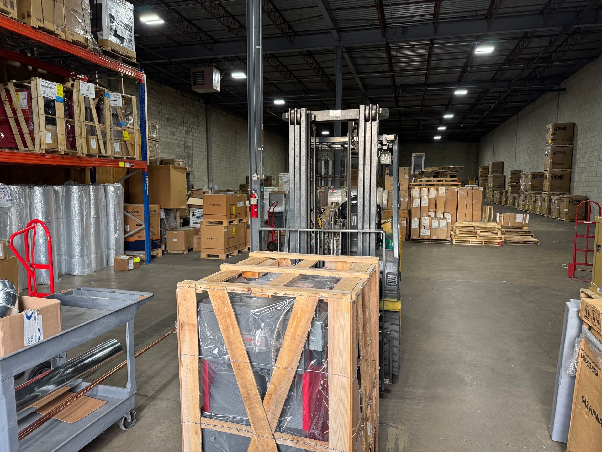A wooden fence is sitting on top of a lush green field.