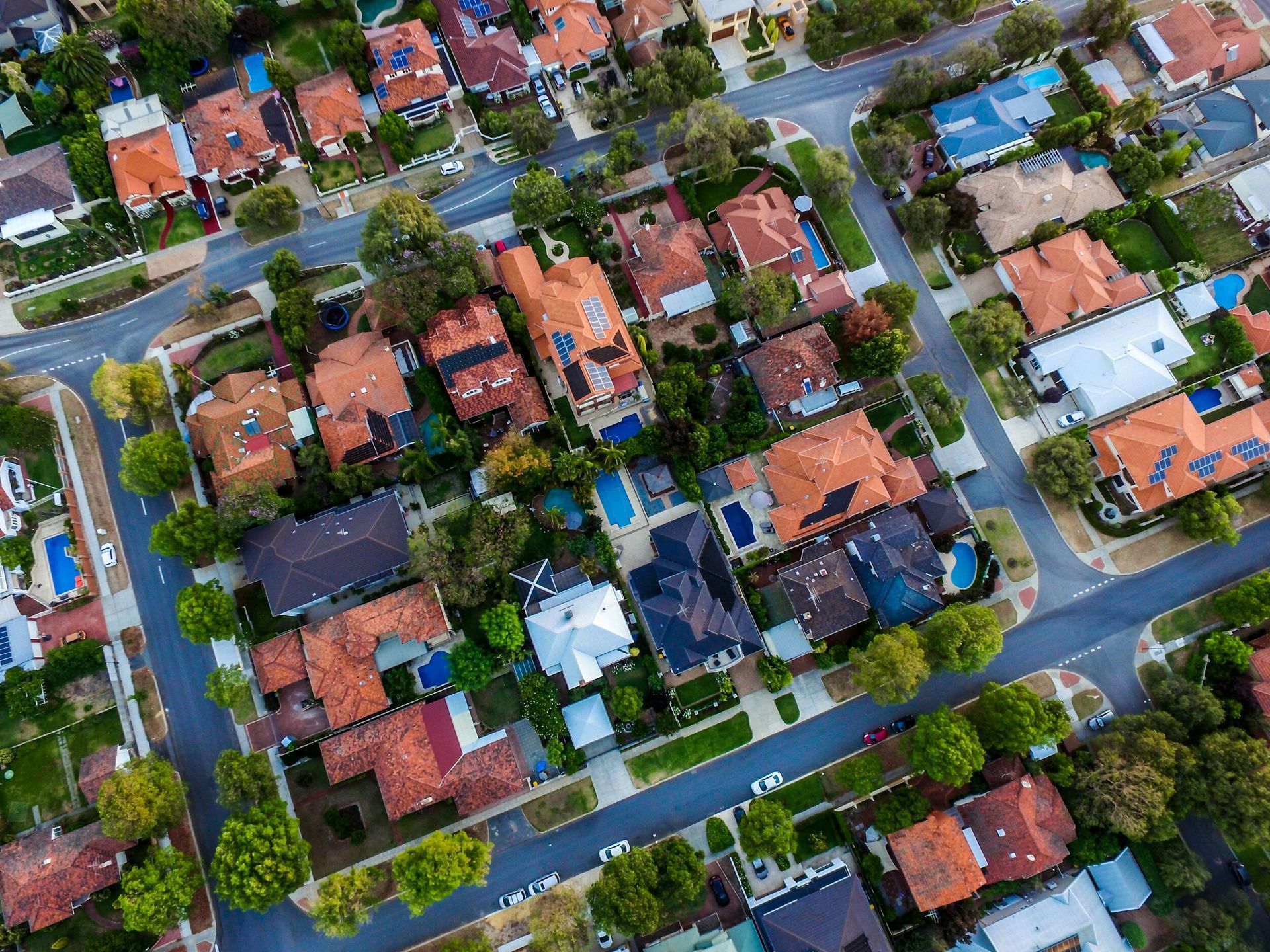 An aerial view of a residential area with lots of houses and trees.
