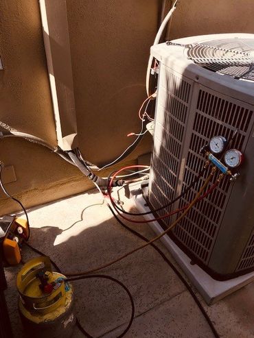 HVAC Tech Working On A Condensing Unit — Huntington Beach, CA — Amm Air Conditioning & Heating