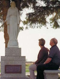 full service cemetery medicine hat two people looking at statue in cemetery