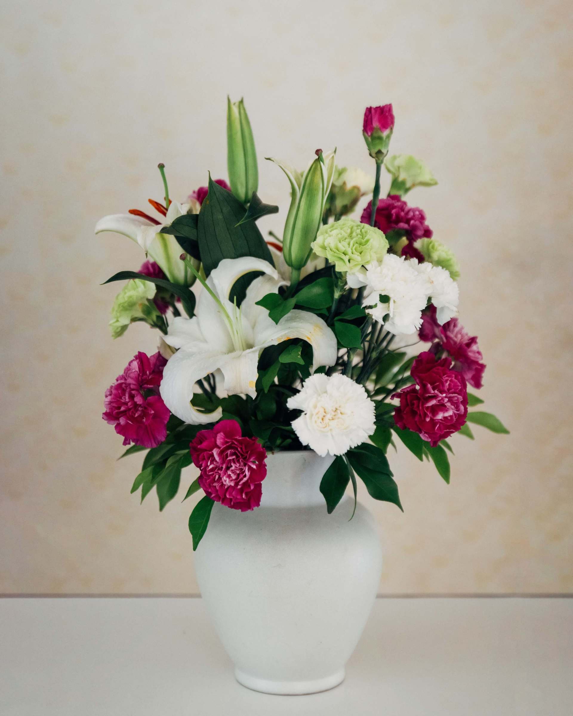 funeral flowers white vase with pink and white flowers