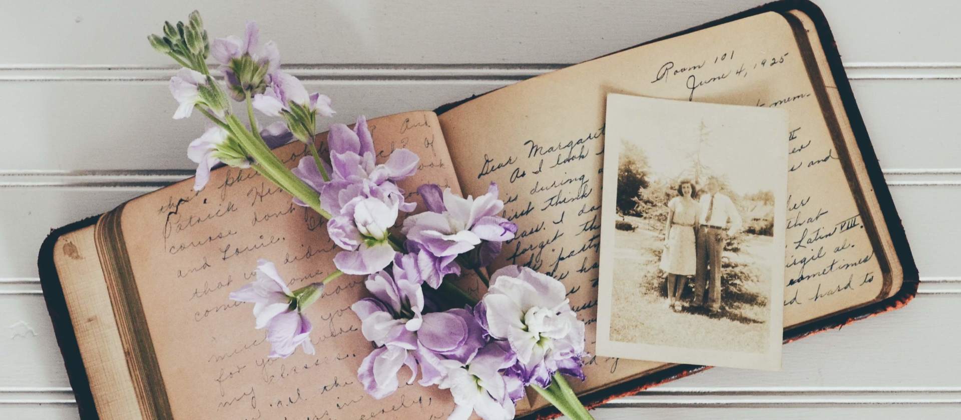 personalizing a funeral service old book and photograph purple flowers