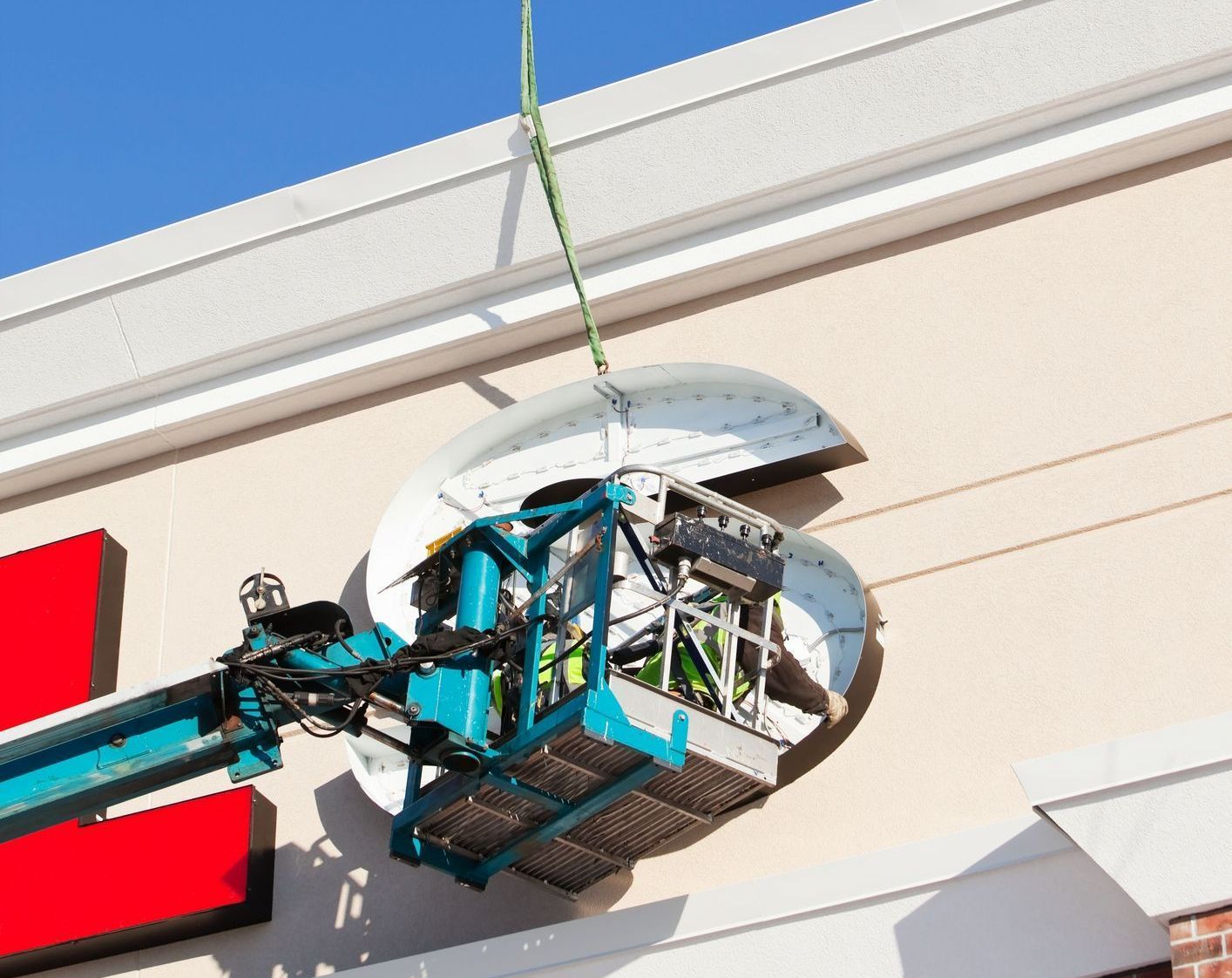 A man is painting a billboard with a brush. A man is painting a billboard with a brush.