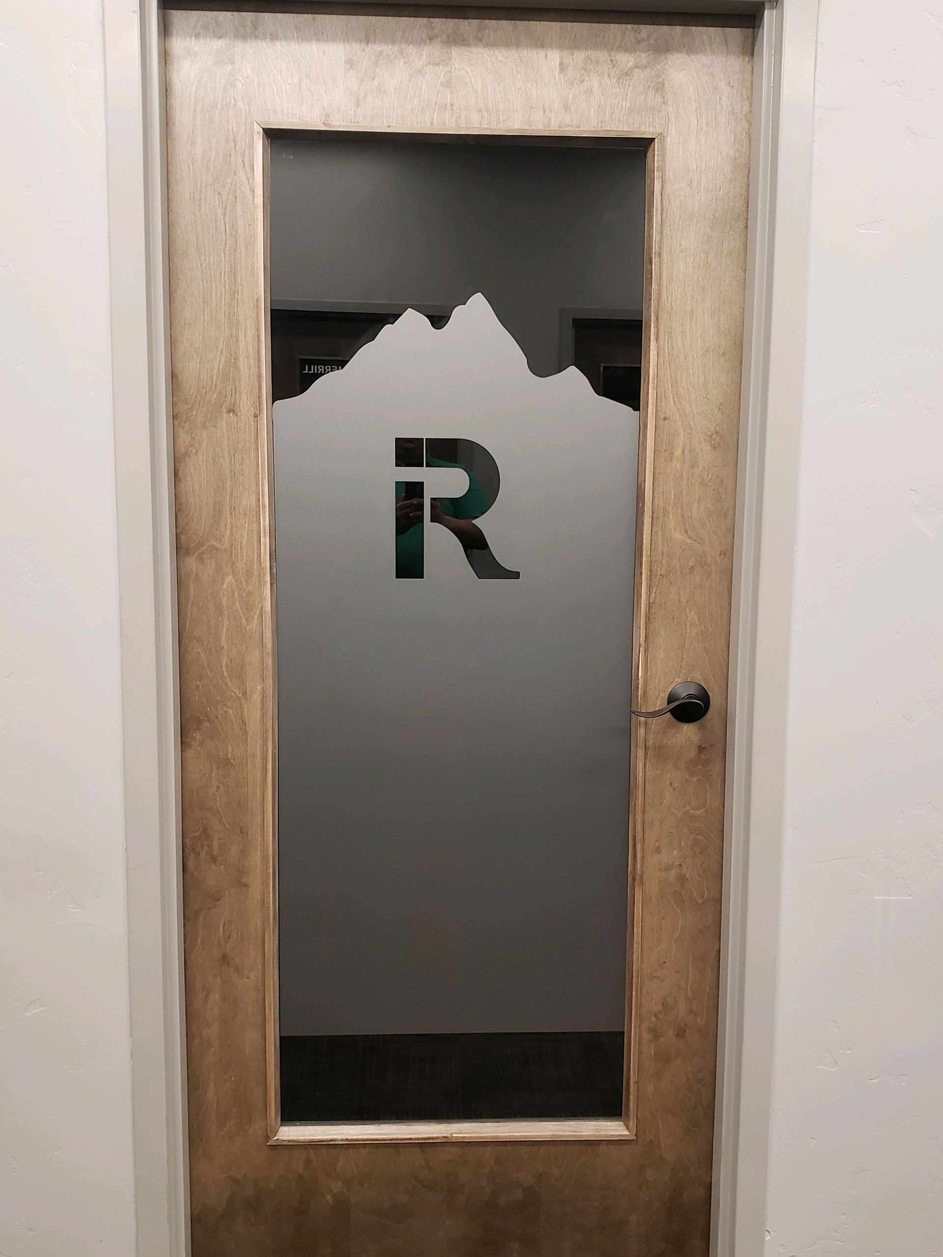 A door with a mountain and the letter r on it. A door with a mountain and the letter r on it.