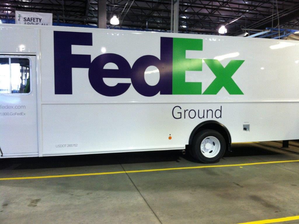 A fedex truck is parked in a warehouse A fedex truck is parked in a warehouse