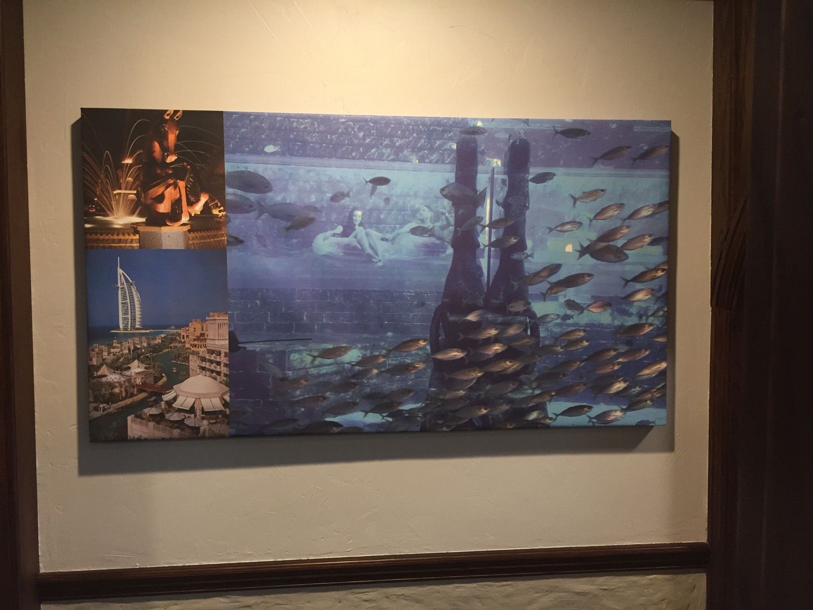 A large painting of fish is hanging on a wall A large painting of fish is hanging on a wall