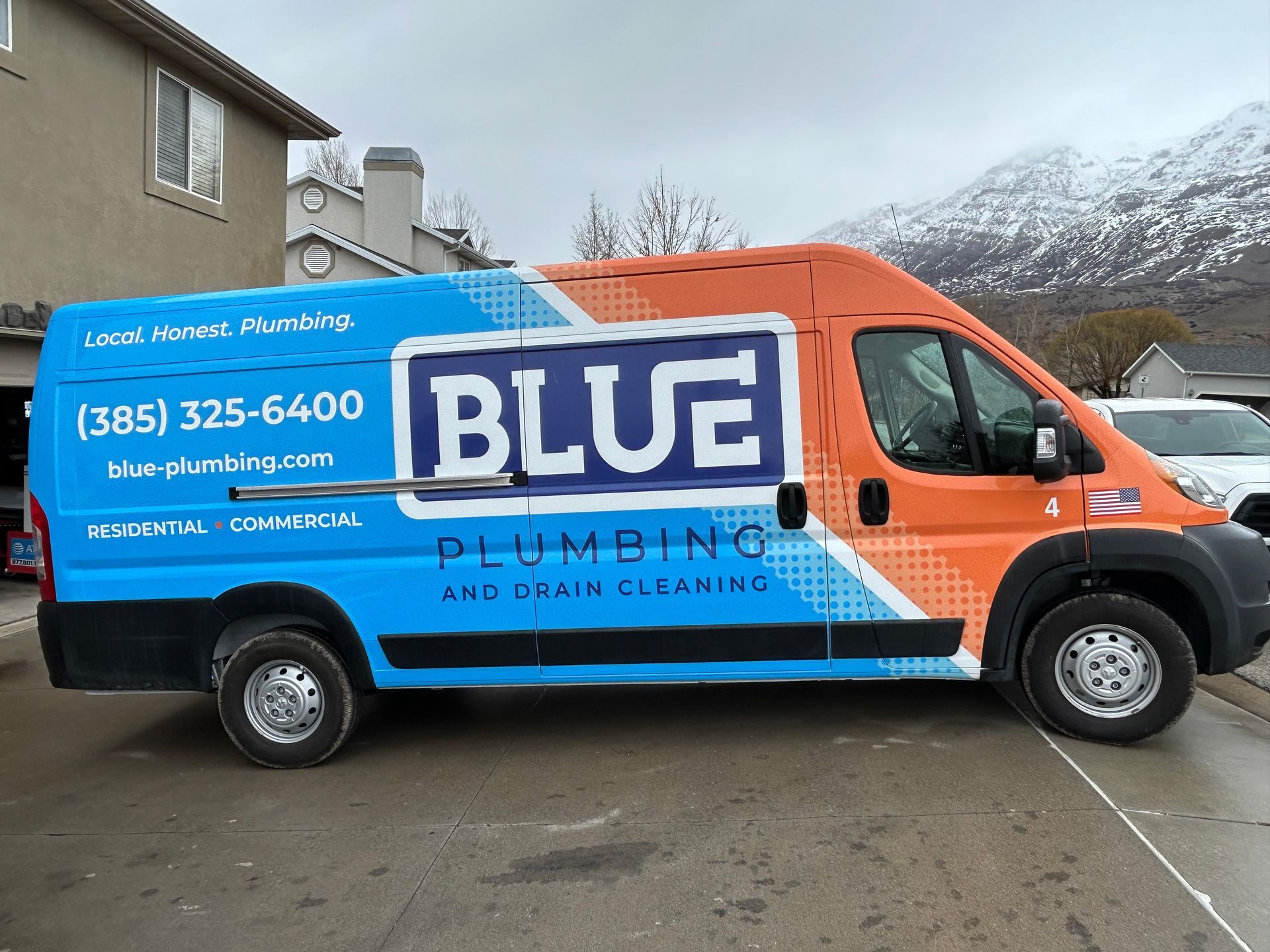 Full Vehicle Wraps Partial Vehicle Wraps Box Trucks & Vans Signage Trailer Wraps & Decals Vehicle Magnets Perforated Window Vinyl Frosted Window Vinyl A blue plumbing van is parked in front of a building.