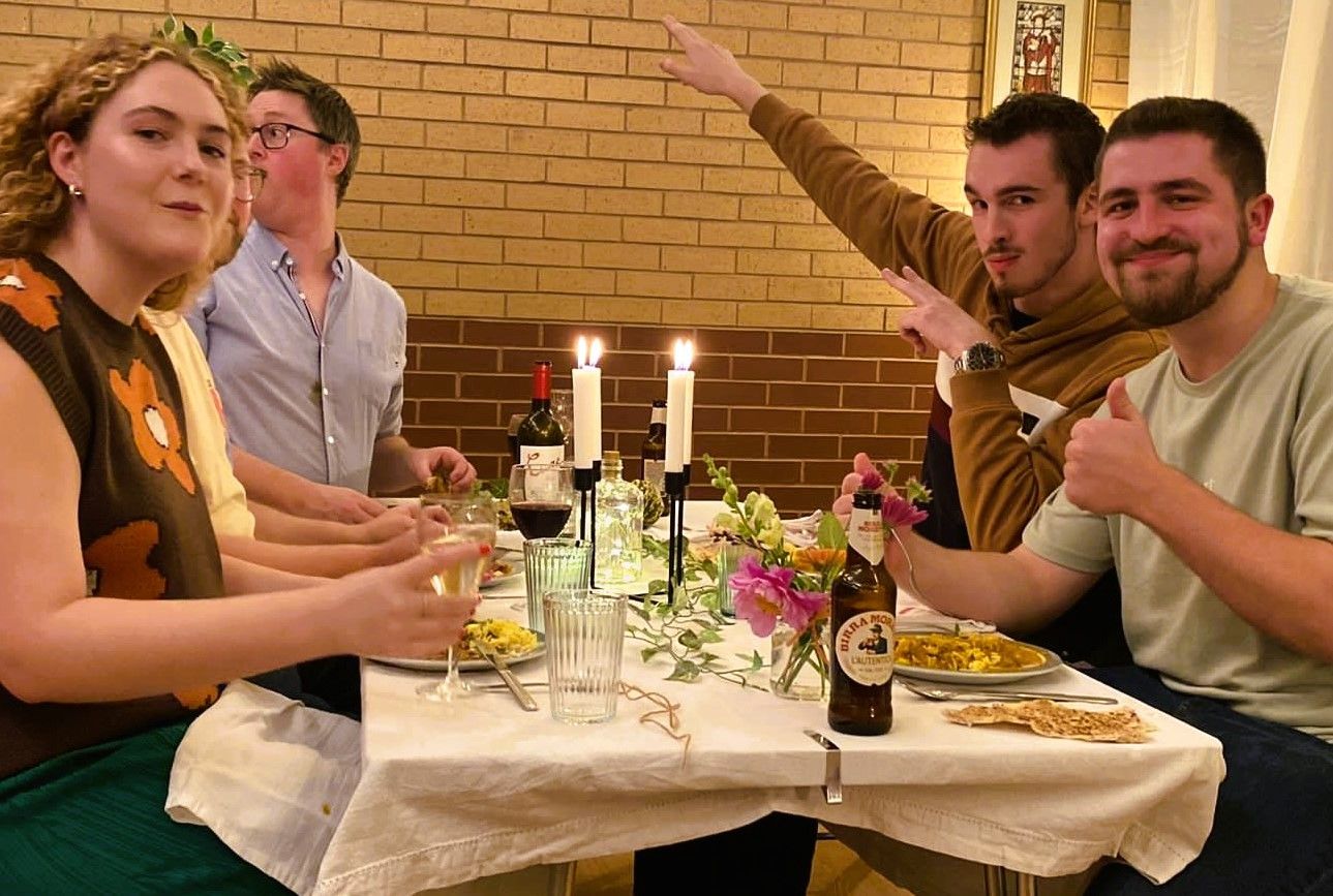 Young adults enjoying a meal at a Feast Night 