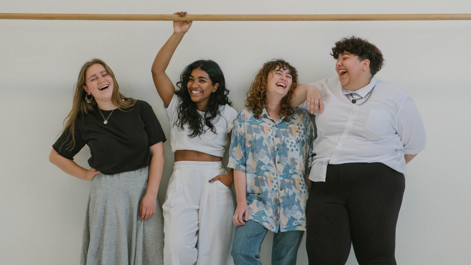 4 women laughing together