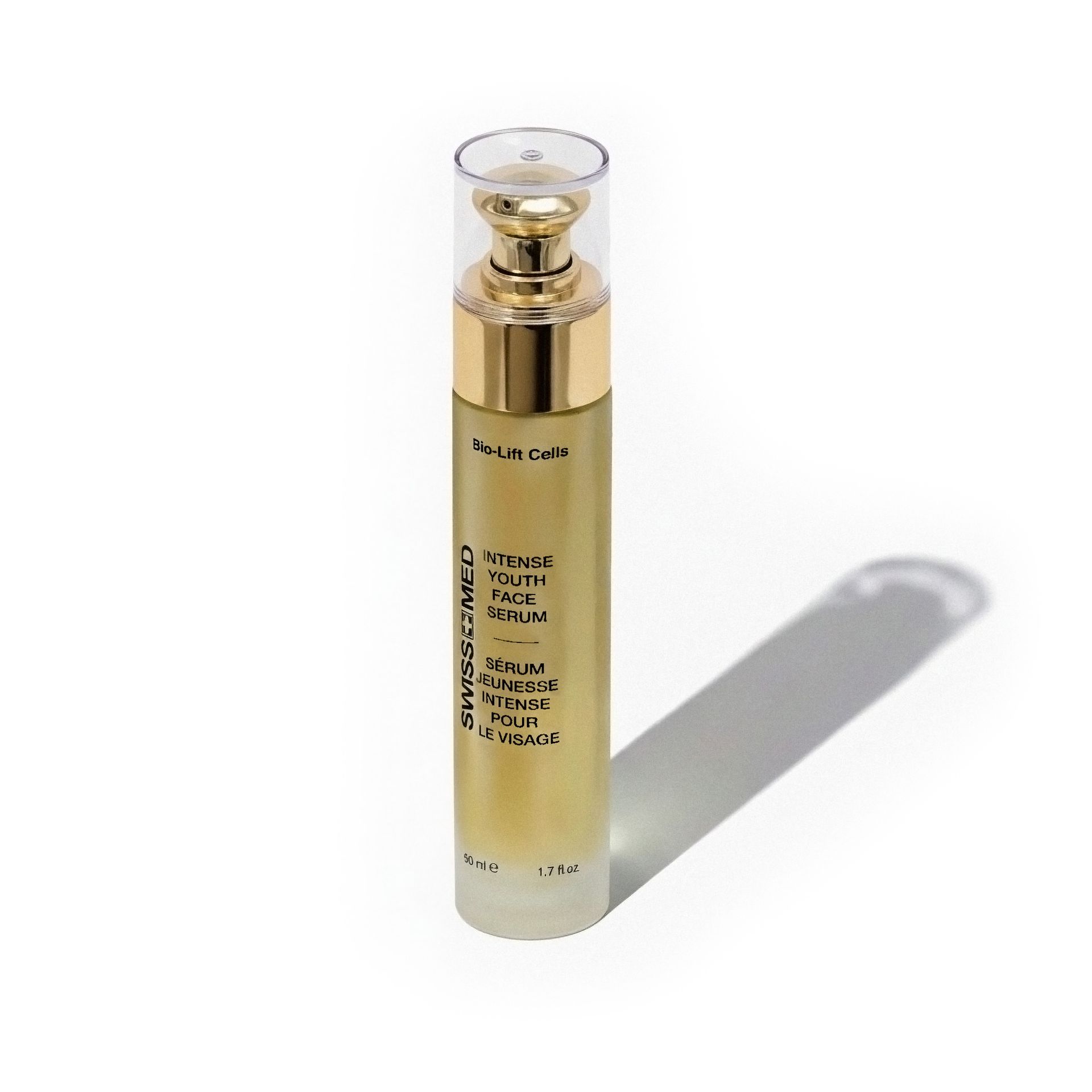 Gold and clear skincare serum bottle with pump, casting a shadow on white.