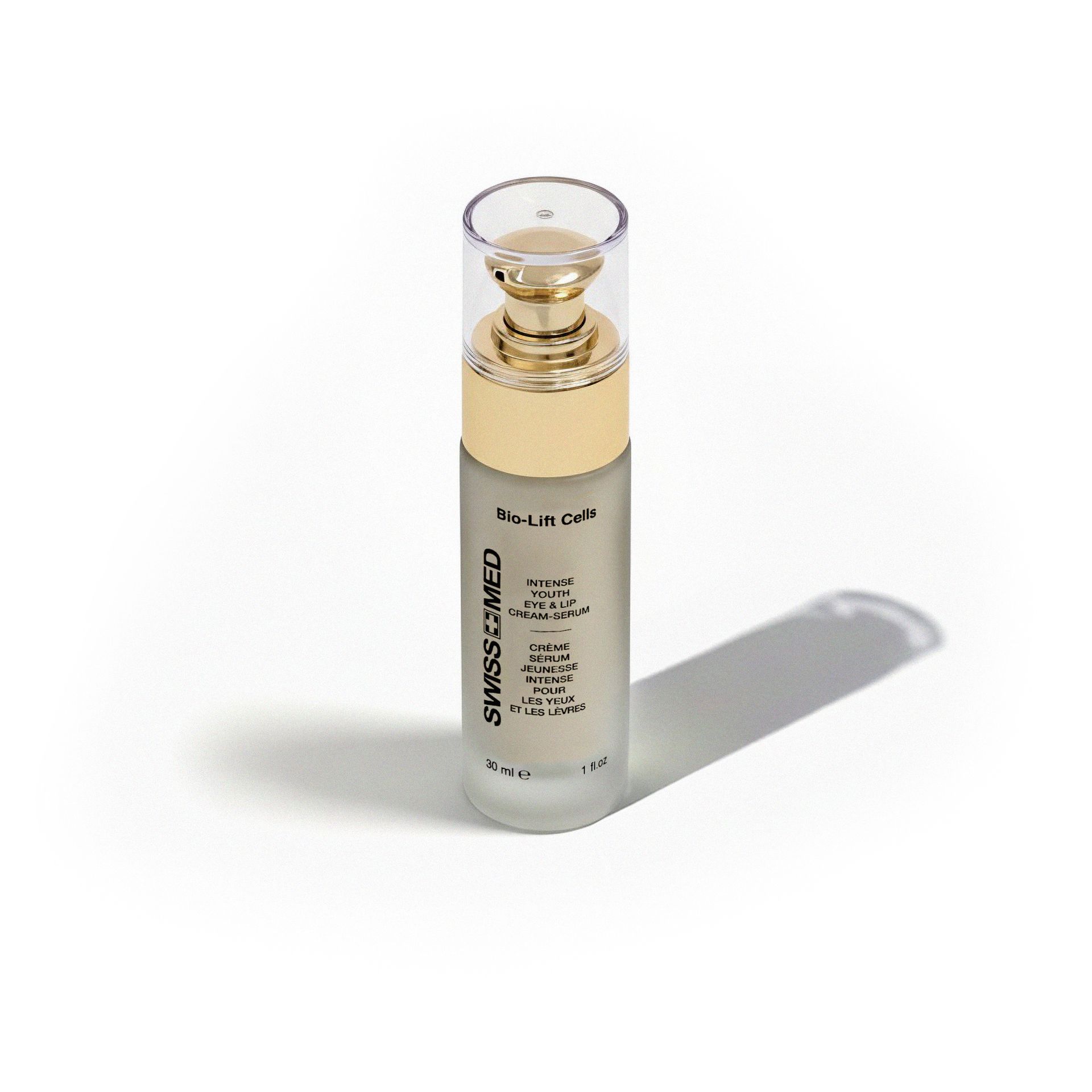 Eye cream bottle with gold accents, cap on, casting a shadow.