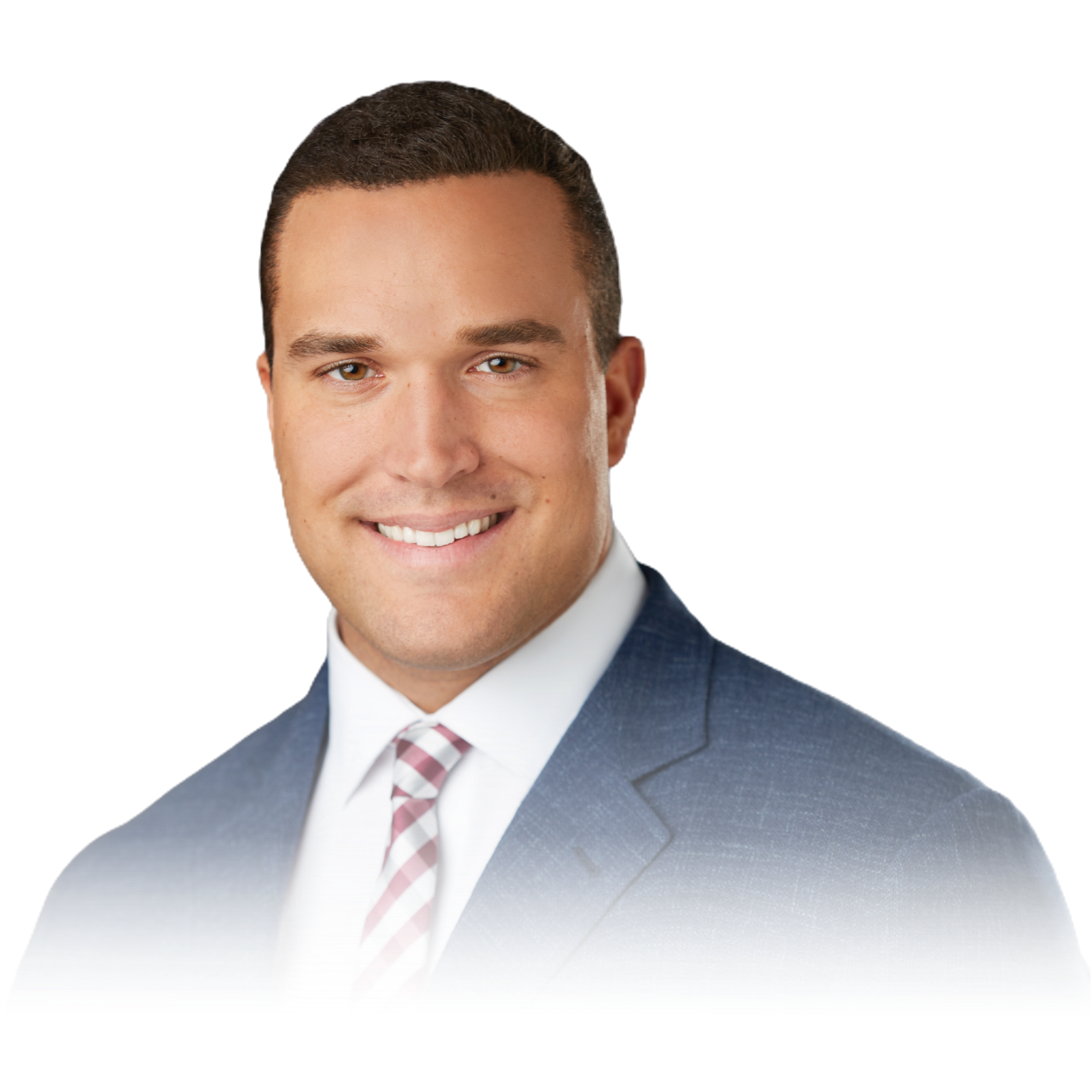 A man in a suit and tie is smiling for the camera