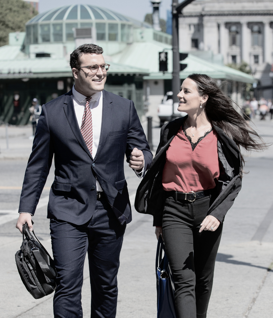 A man and a woman are walking down the street