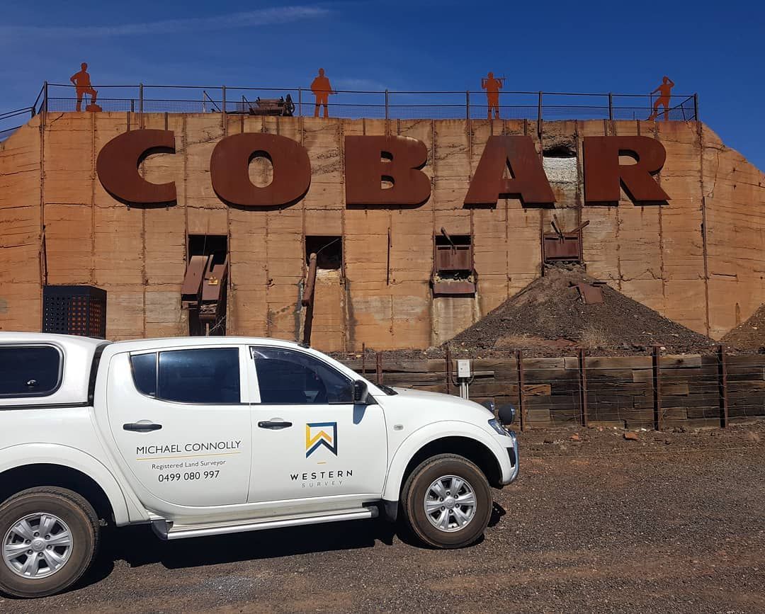 A White Truck Is Parked In Front Of A Building That Says Cobalt — Western Survey Pty Ltd In Cobar, NSW