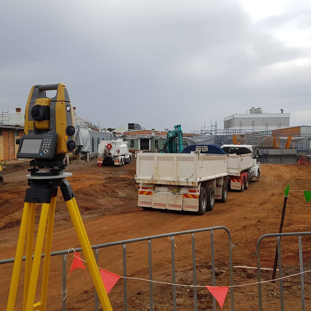 A Truck Is Parked In A Dirt Field With A Yellow Tripod In The Foreground — Western Survey Pty Ltd In Dubbo, NSW