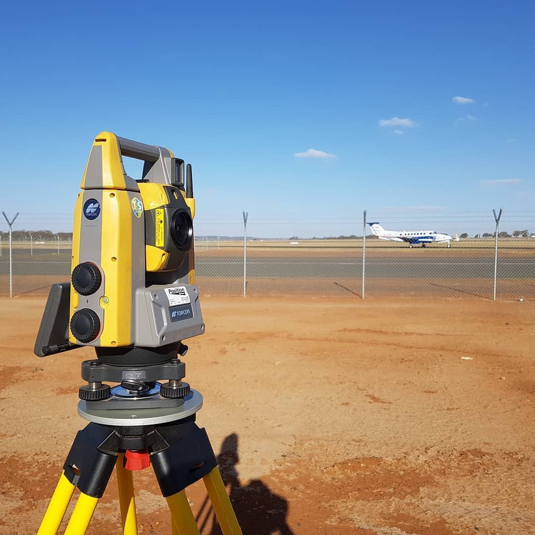 A Yellow And Gray Theodolite Is On A Tripod In A Field — Western Survey Pty Ltd In Bourke, NSW