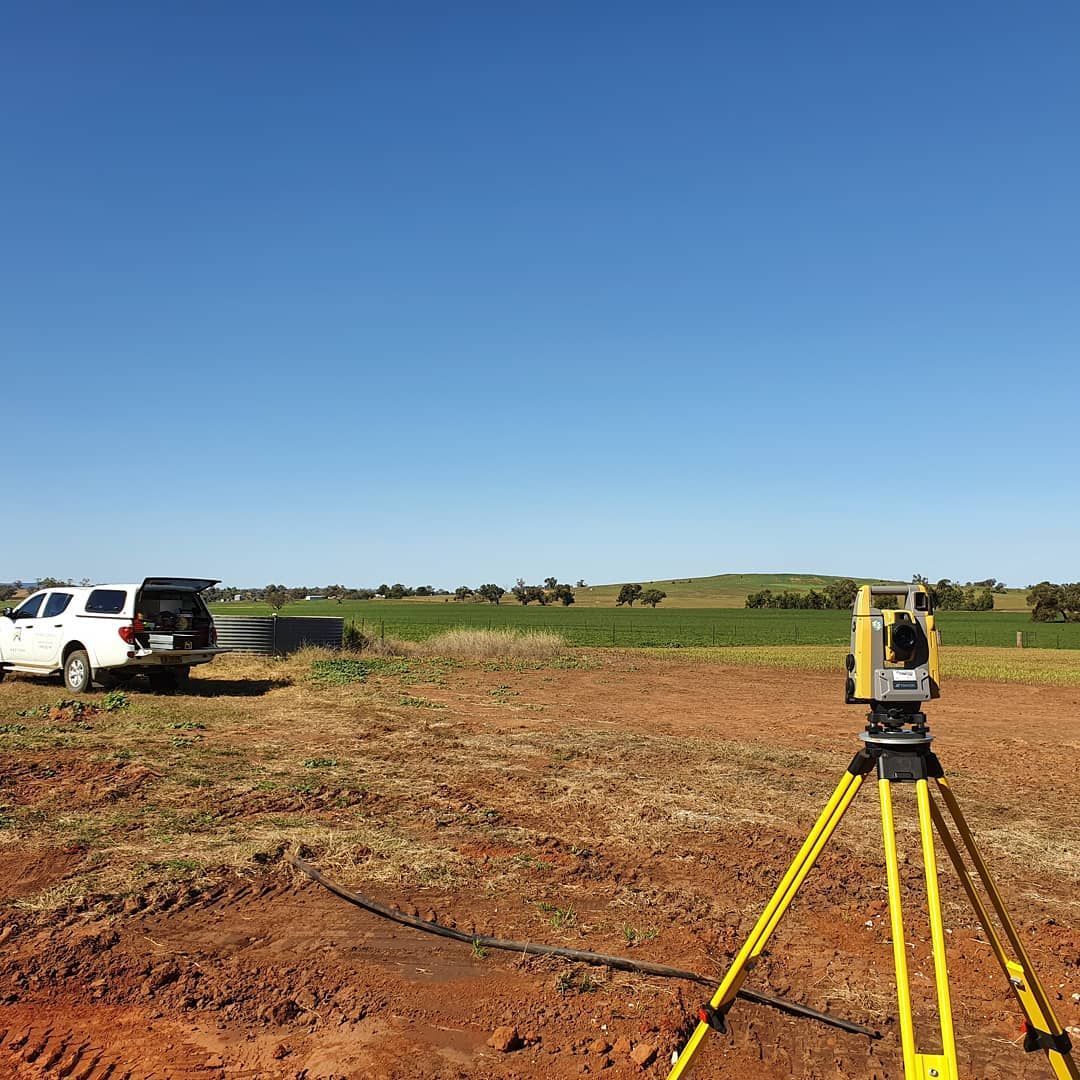 A Truck Is Parked In A Dirt Field Next To A Total Station — Western Survey Pty Ltd In Lightning Ridge, NSW