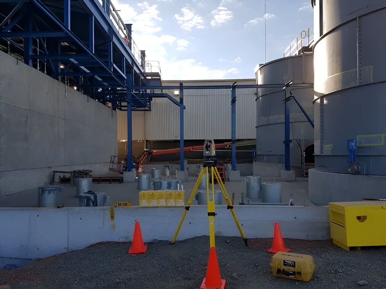 A Tripod Is Sitting In Front Of A Large Building — Western Survey Pty Ltd In Dubbo, NSW