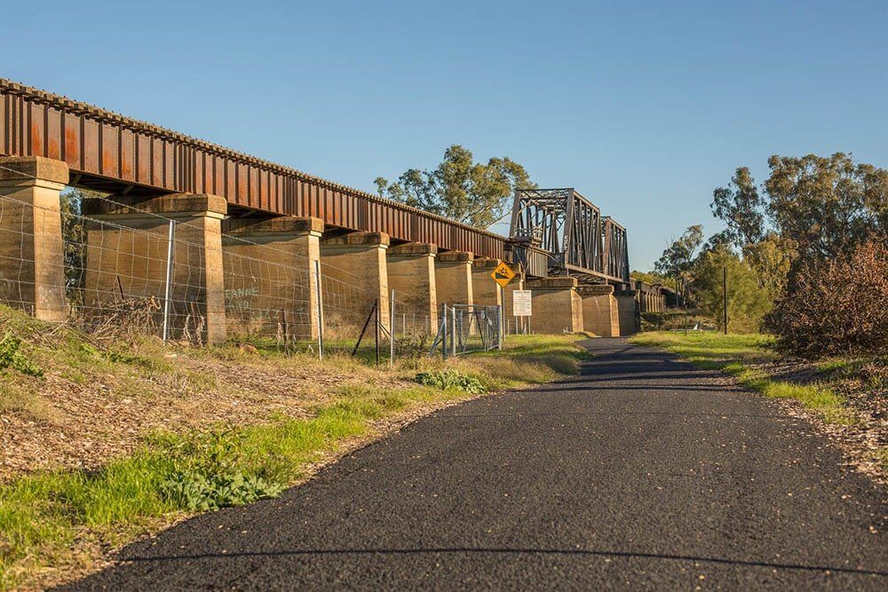 A Road With A Train Bridge In The Background — Western Survey Pty Ltd In Dubbo, NSW
